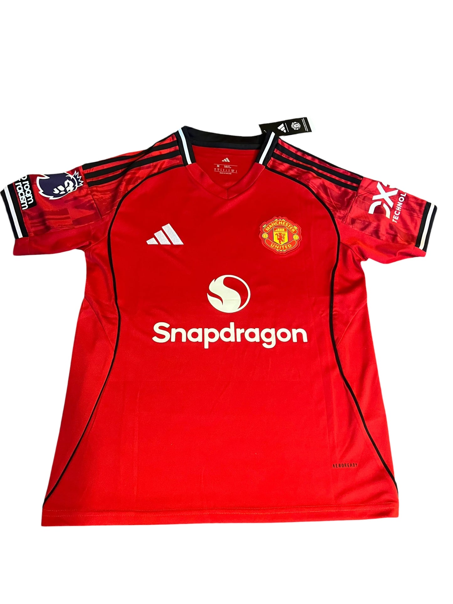 rm memorabilia Manchester United home football shirt in red with black details, club crest, and sponsor logo.